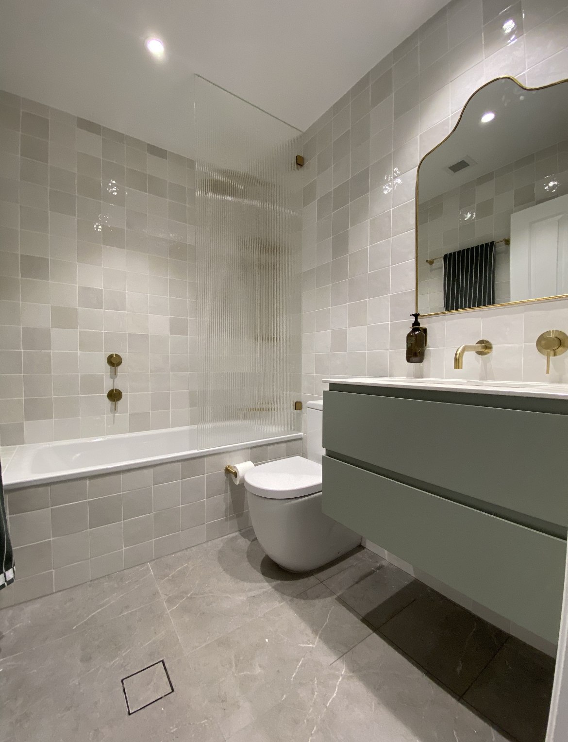 Grey tile bathroom with fluted glass shower screen