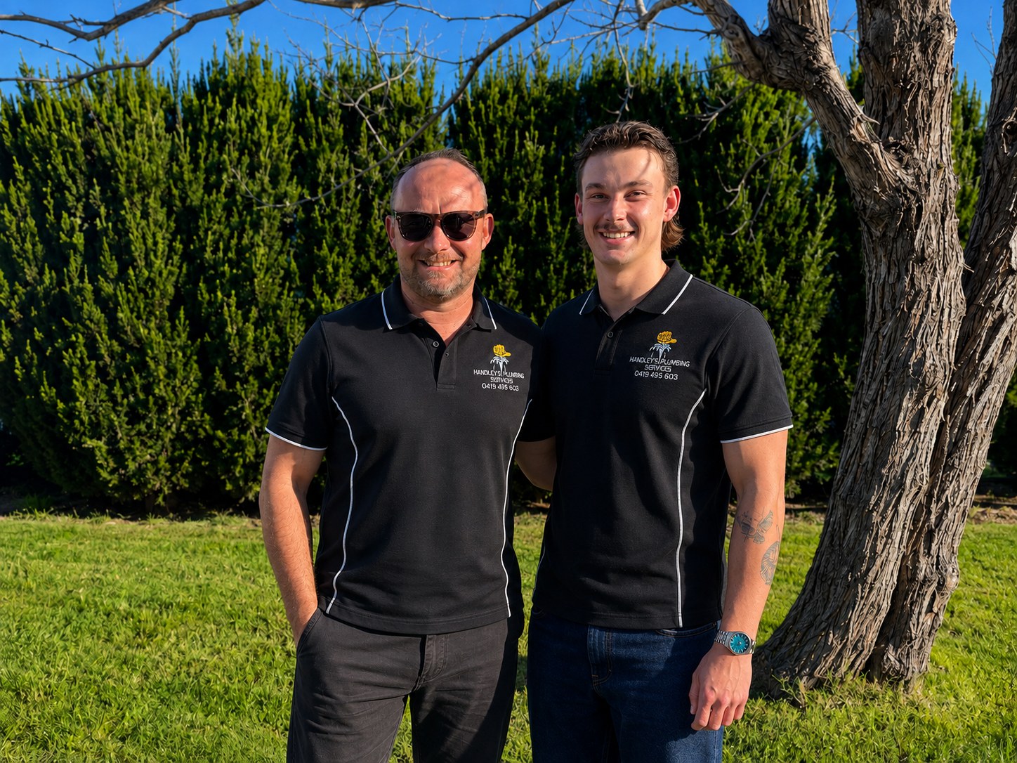 Trent Handley and his son in Handley's Plumbing Services uniform